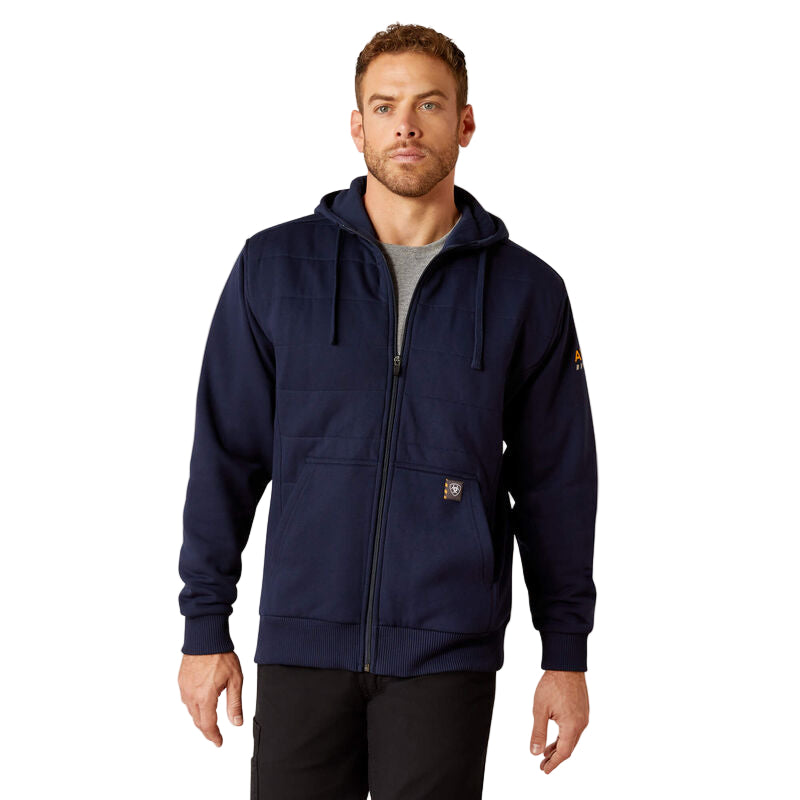 A man wearing a navy full zip hoodie with an adjustable hood and a kangaroo pocket, with a subtle logo on the sleeve.