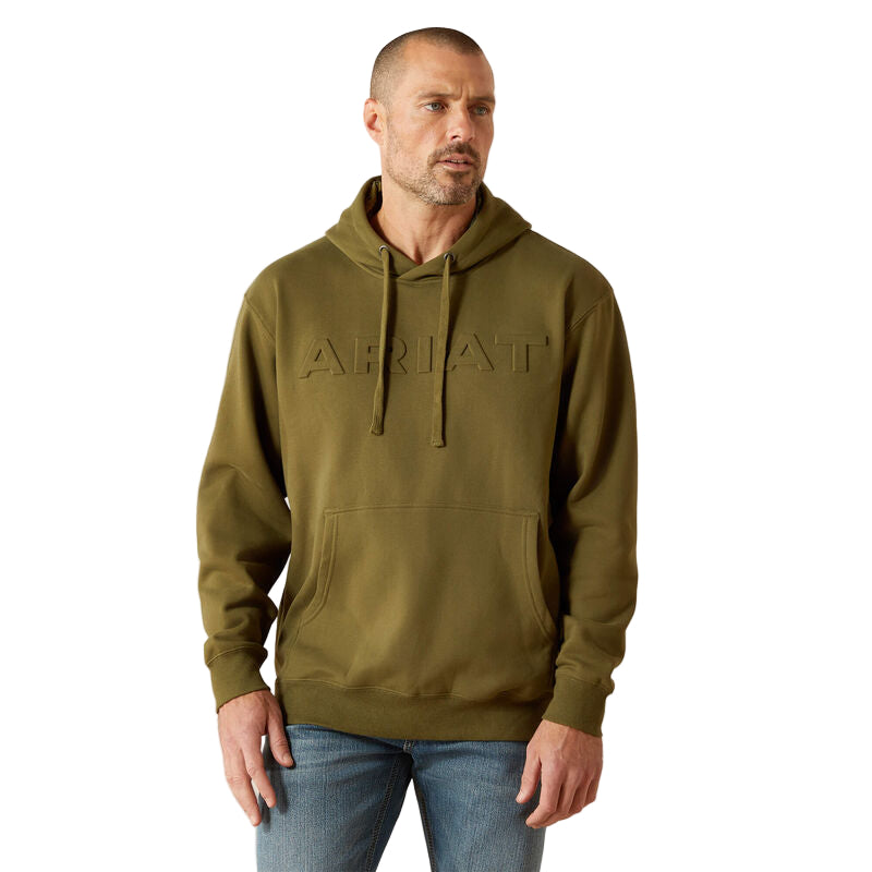Man wearing a green hoodie with 'Ariat' branding on a beige background