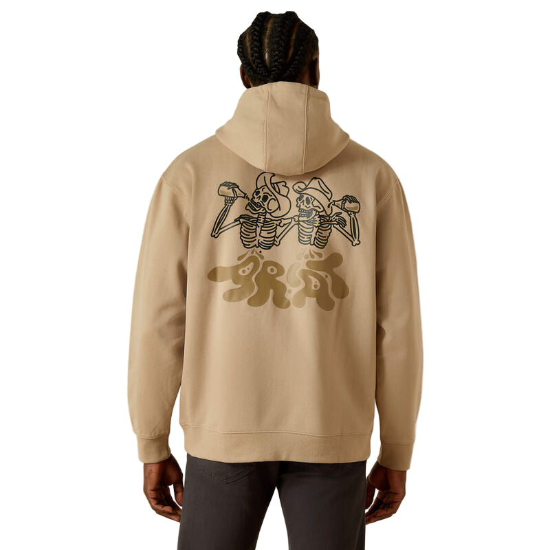 Beige hoodie with graphic designs on the back, worn by a person against a beige background