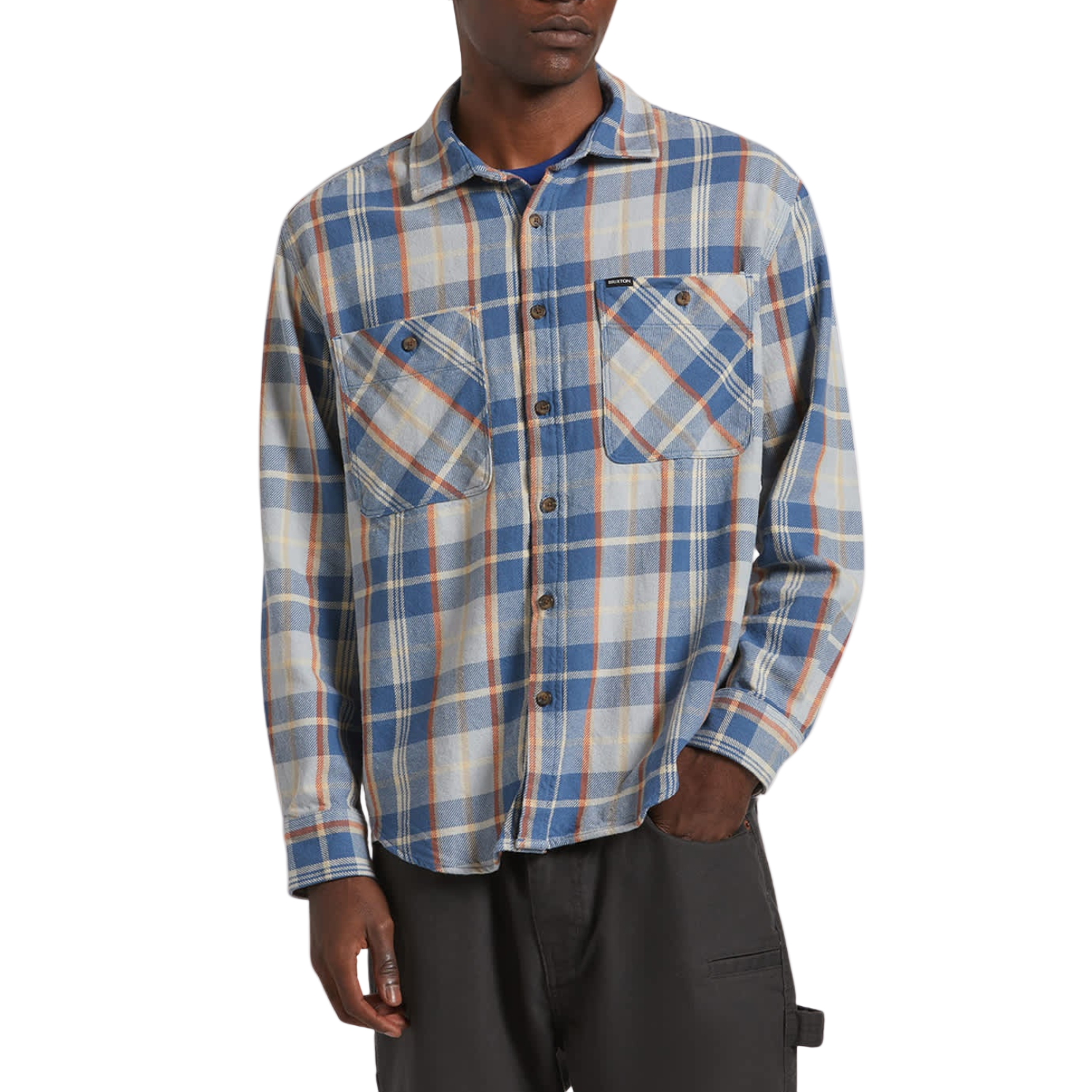Person wearing a blue and beige plaid shirt on a white background