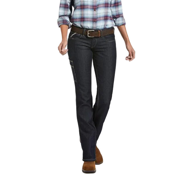 A model from the waist down wearing dark wash denim jeans, a brown belt, a blue and red plaid shirt, and brown boots, shown against a plain white background.
